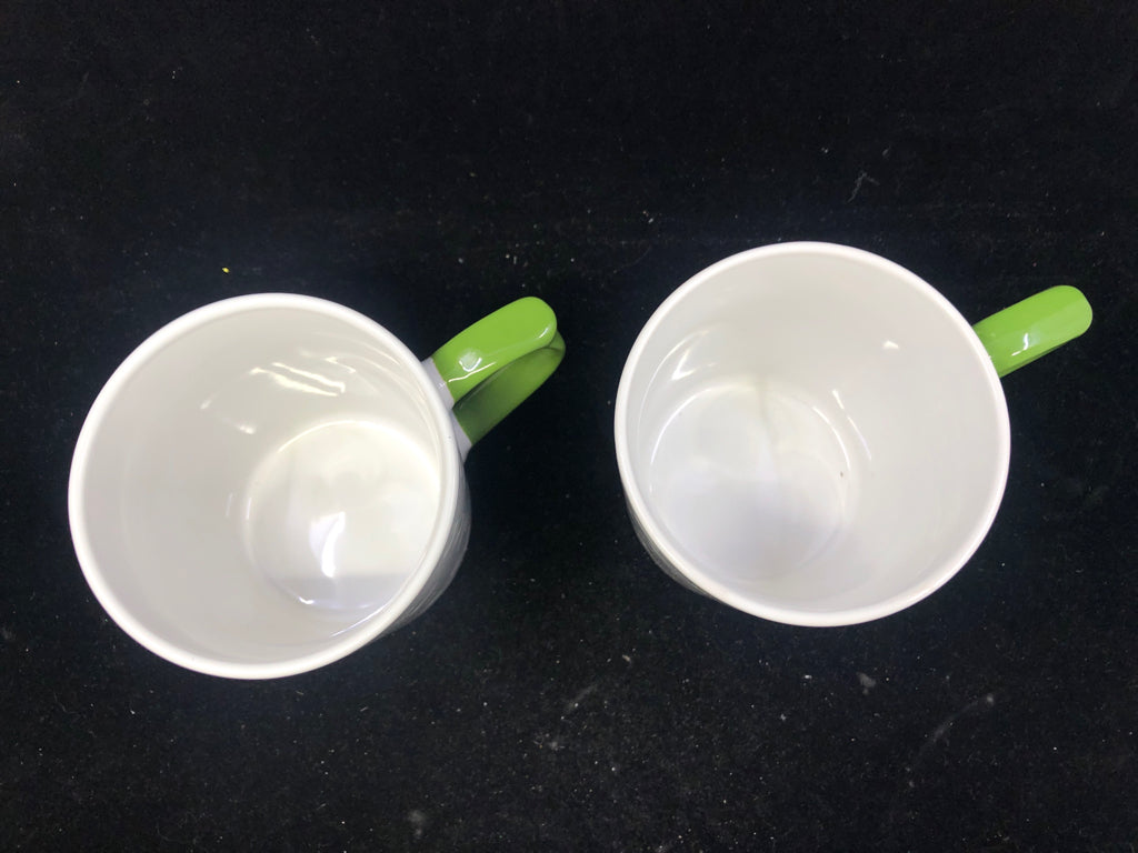 2 GREEN AND WHITE MUGS.