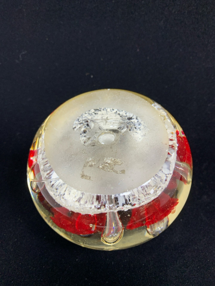 CLEAR GLASS PAPERWEIGHT W/WHITE/RED FLORAL DESIGN.