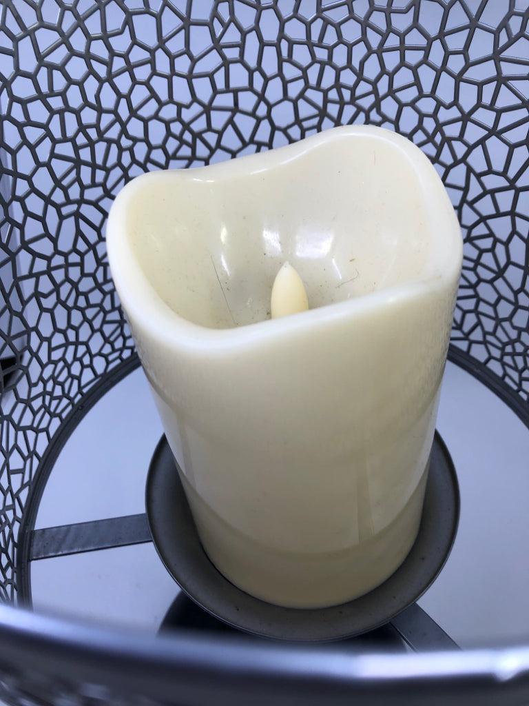 BLACK FOOTED PILLAR CANDLE HOLDER W/ GREY PIERCED METAL SHADE.