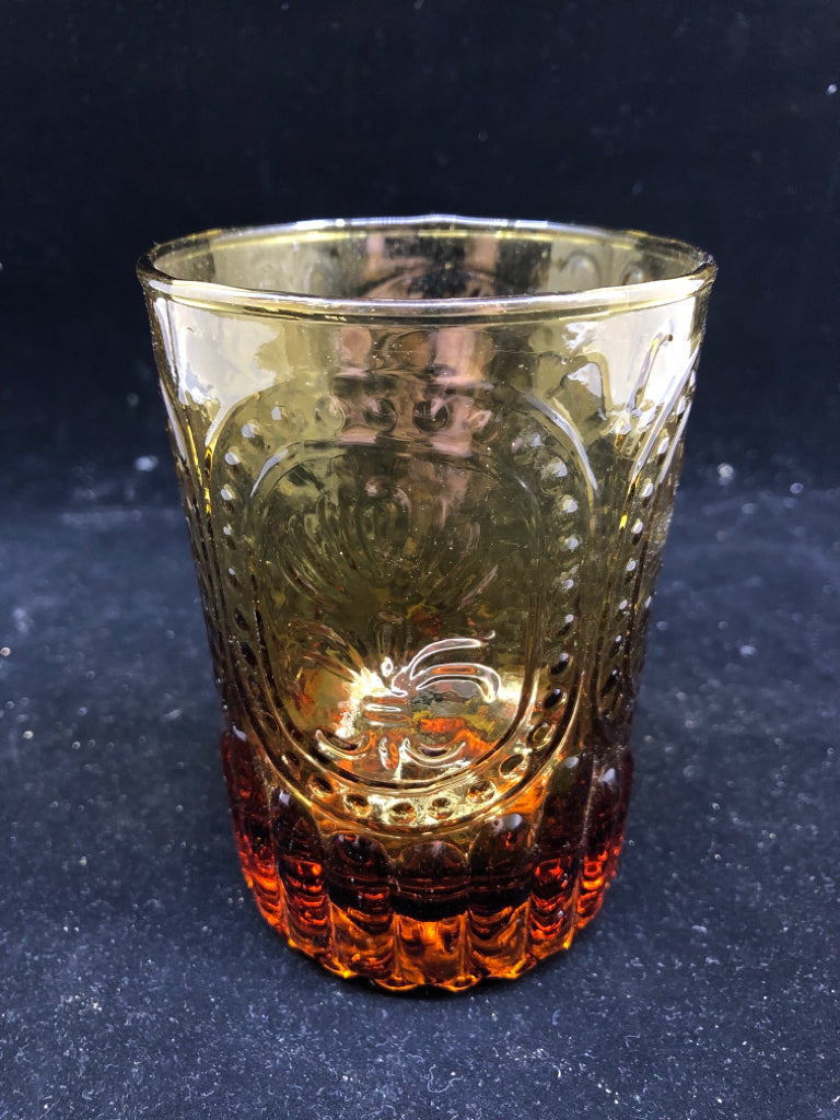 AMBER GLASS EMBOSSED TEALIGHT HOLDER.