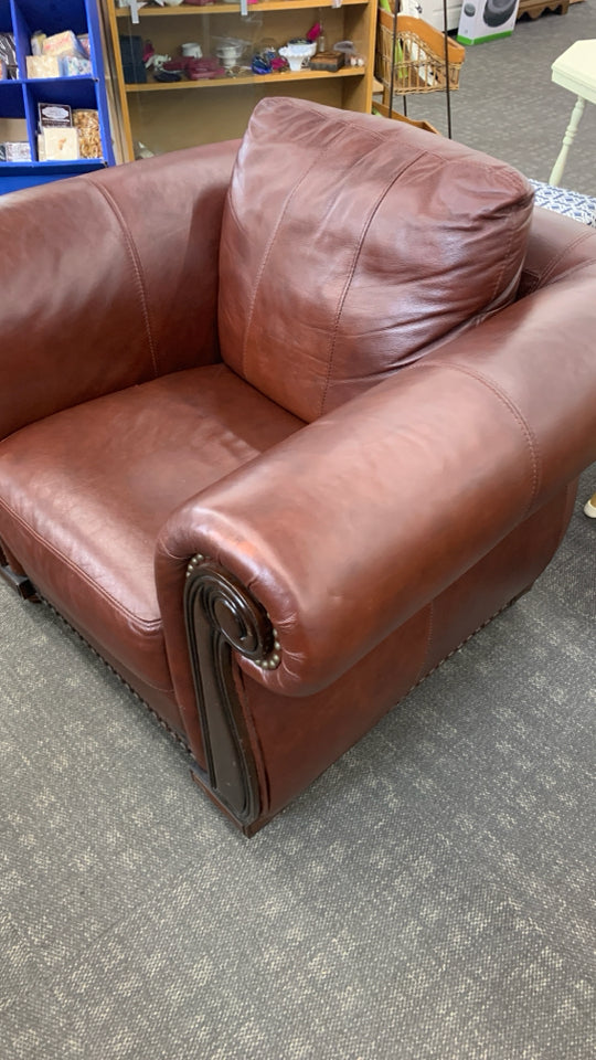RED LEATHER CHAIR W/WOODEN UPHOLSTERY.