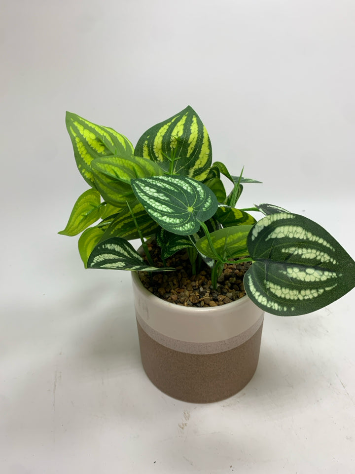 FAUX PLANT IN TAN CERAMIC POT.
