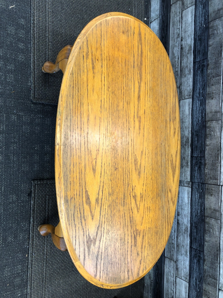OAK WOOD OVAL COFFEE TABLE .