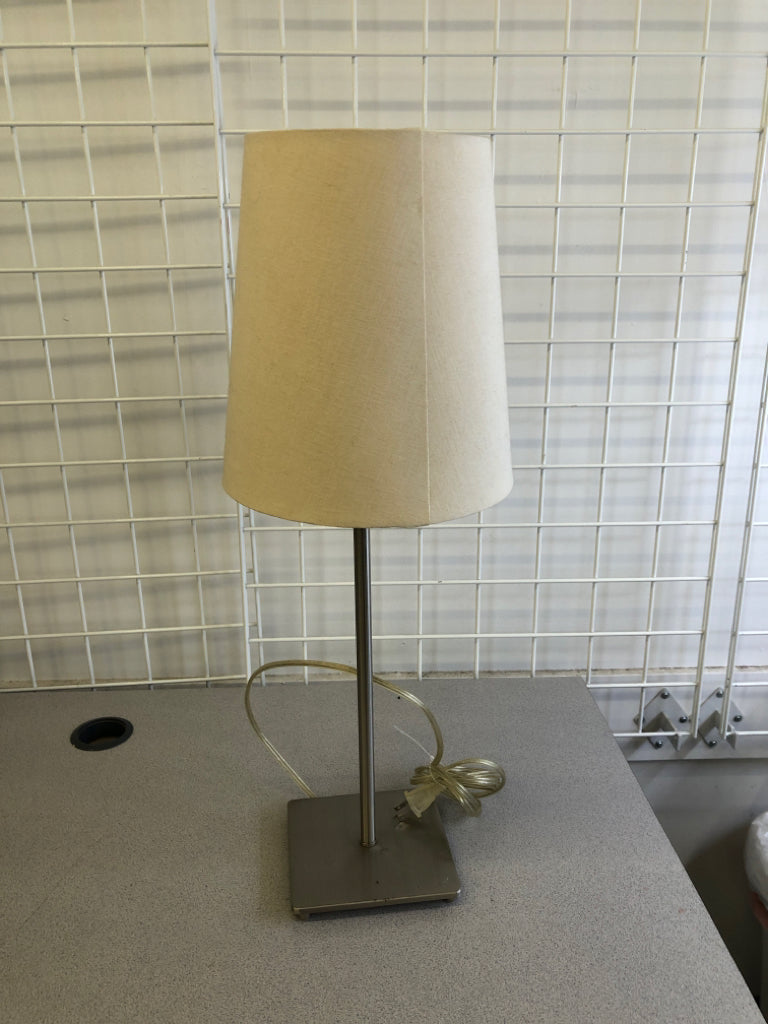 SILVER SKINNY BASE LAMP W/ OFF WHITE SHADE.