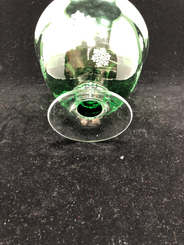 GREEN GLASS FOOTED BOWL W/EMBOSSED SNOWFLAKES.