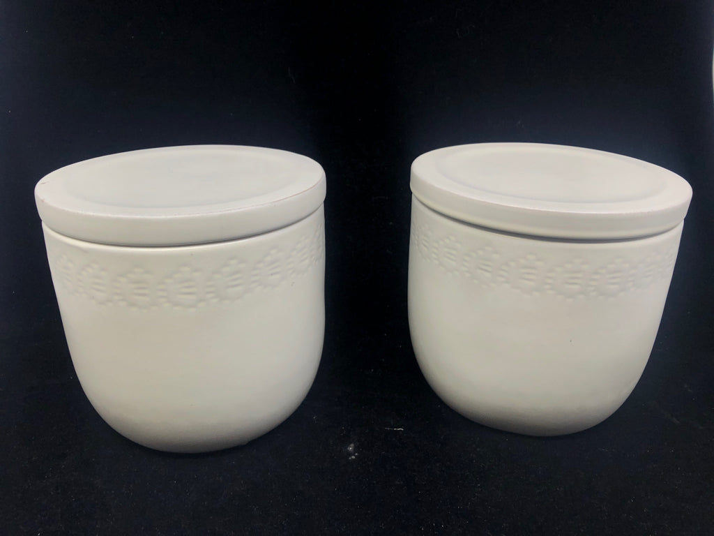 2 CREAM EMBOSSED EDGE STONEWARE CANISTERS.