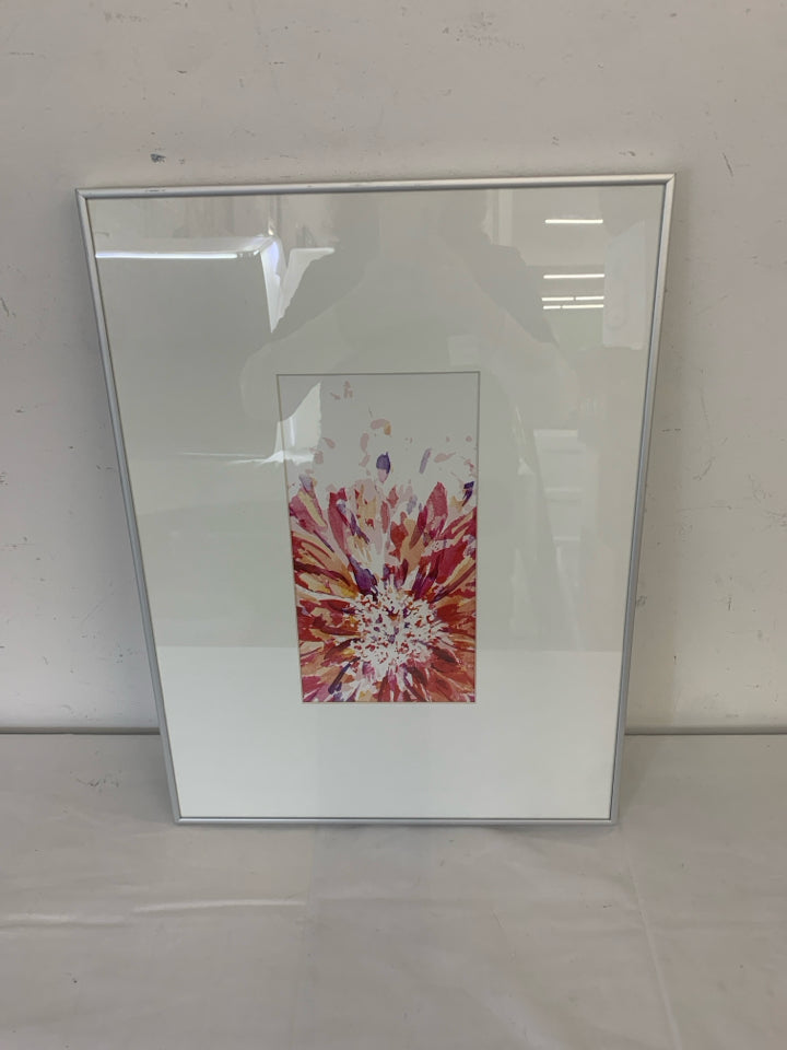 COLORED STARBURST IN WHITE FRAME SILVER TRIM WALL ART.