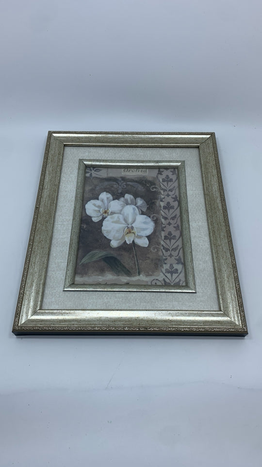 WHITE ORCHID PRINT IN SILVER FRAME.