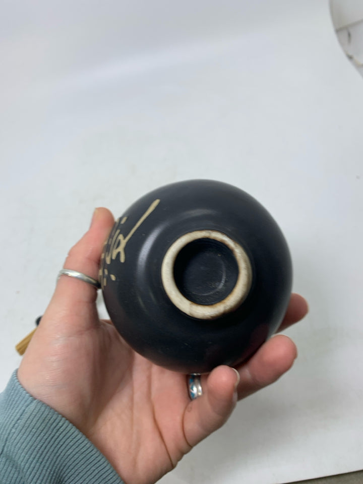 SMALL GINGER JAR W/ STICKS THROUGH TOP & SYBOLS.