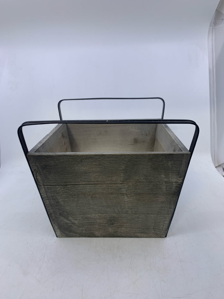 GREY PLANTER W/ GALVANIZED METAL SNOWFLAKE BLACK HANDLES.