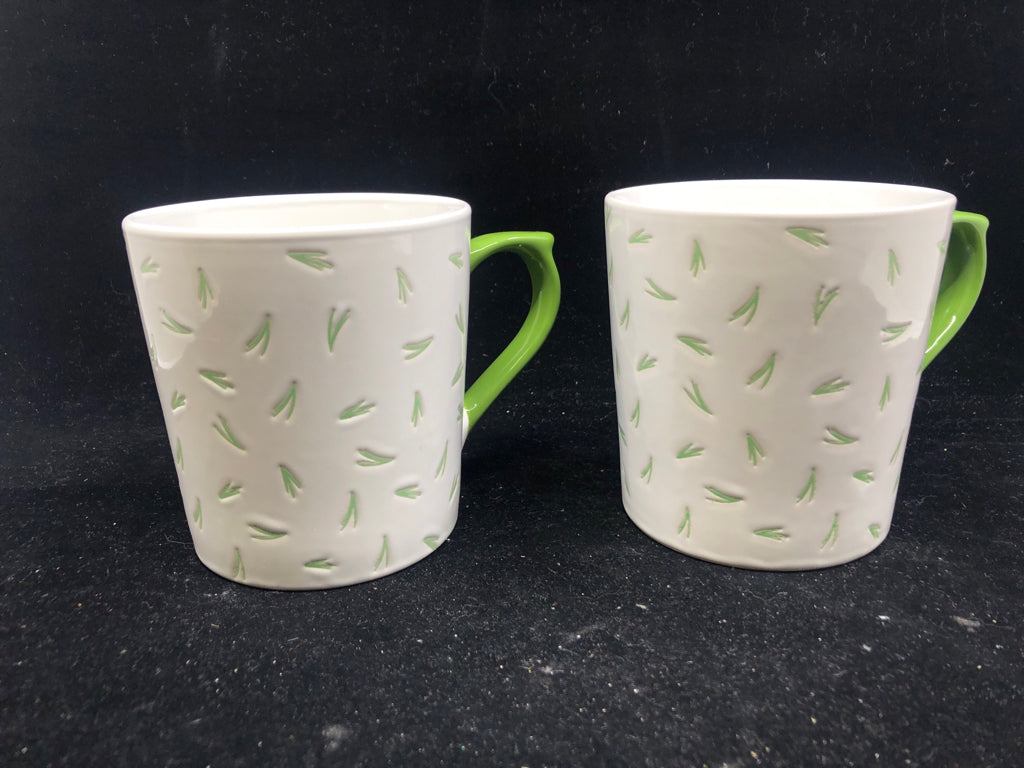 2 GREEN AND WHITE MUGS.