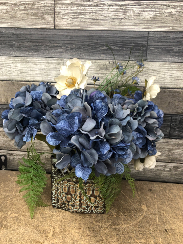 BLUE FLORAL BOUQUET IN DETAILED TIN PLANTER.