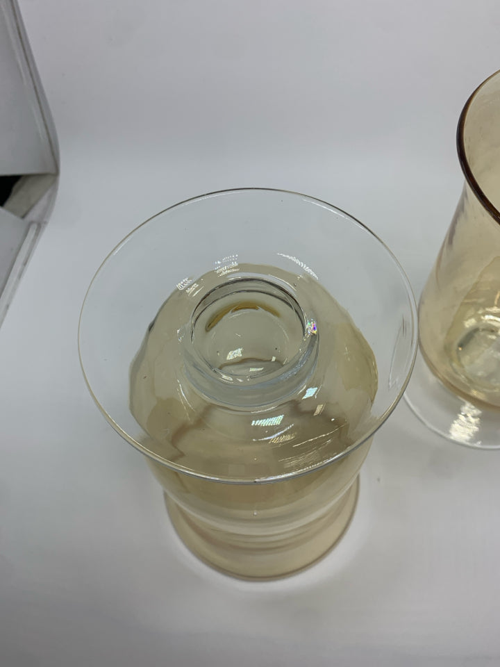2 AMBER IRIDESCENT FOOTED HURRICANE VASES.