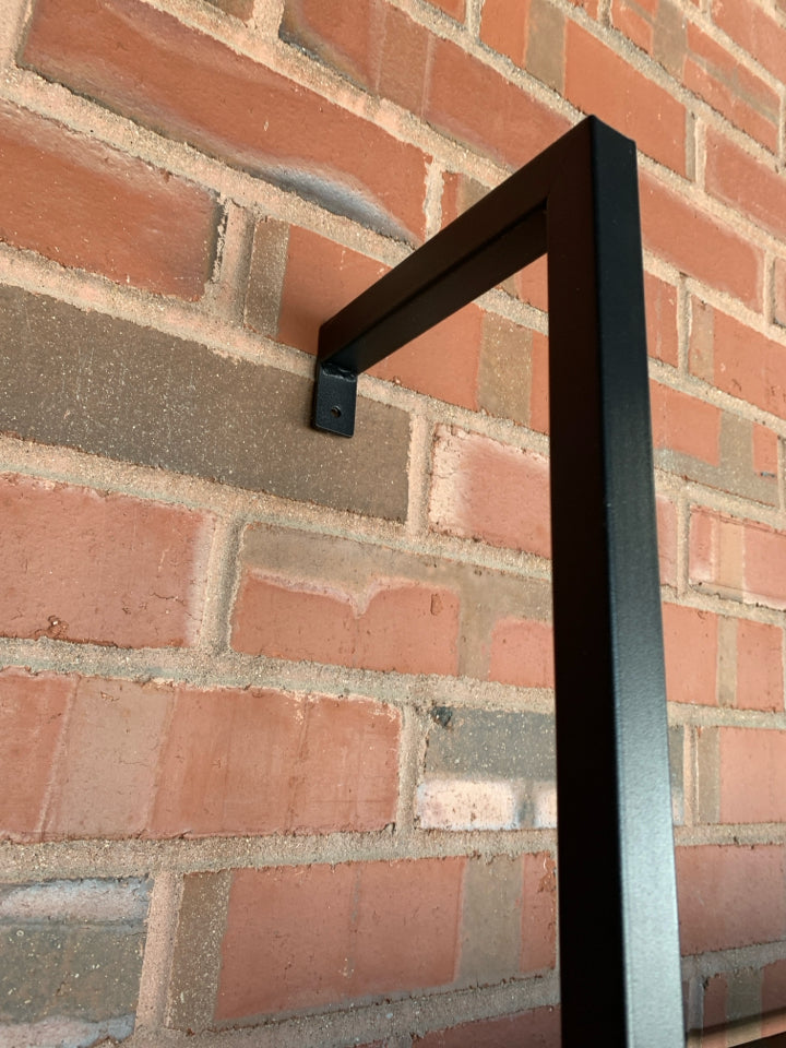 DARK FRAMED LADDER-STYLE WALL-MOUNT BOOKSHELF.
