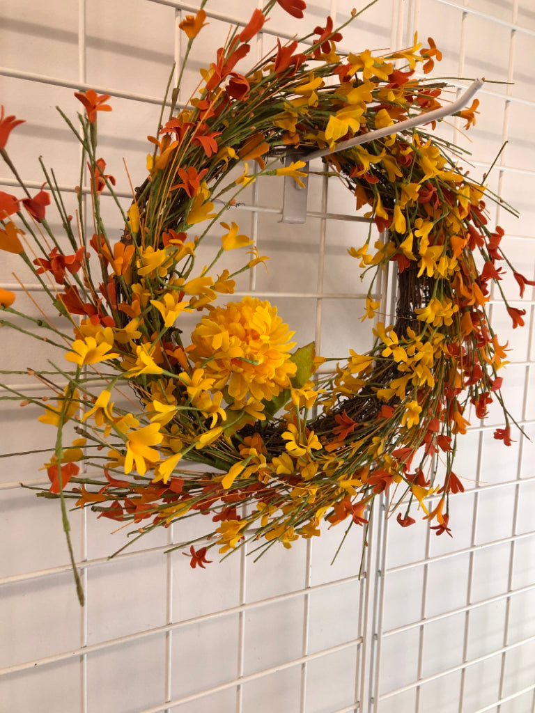 ORANGE/ YELLOW FLOWWRS STICK WREATH.
