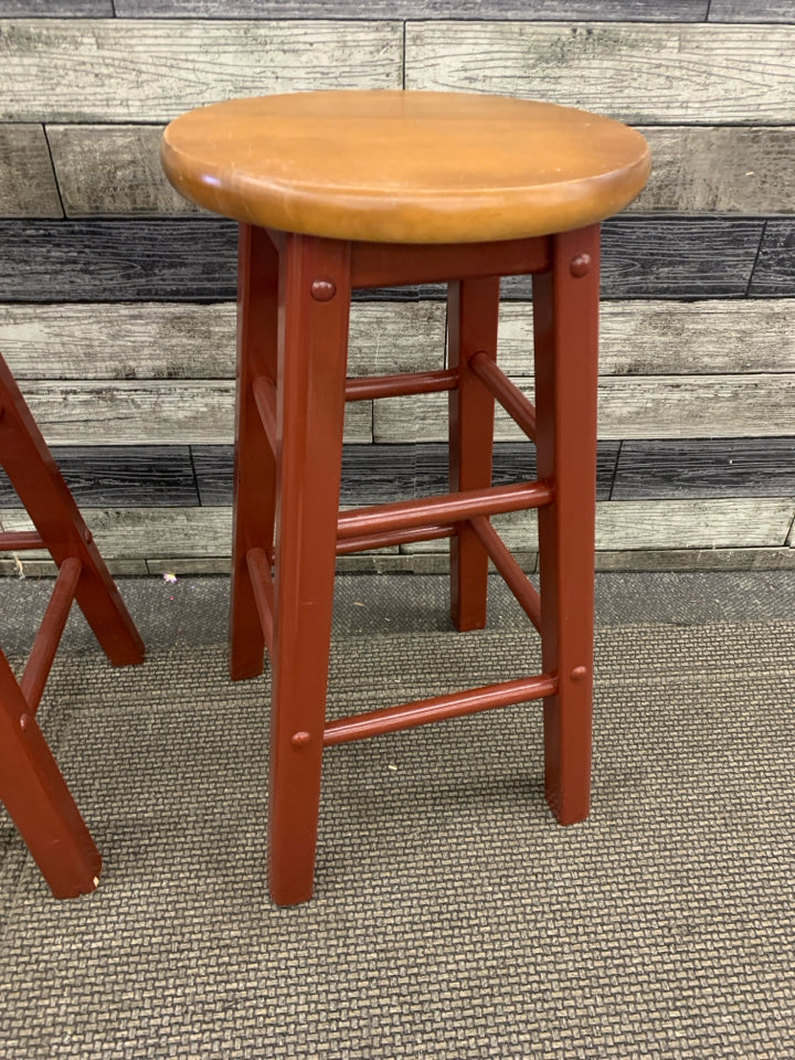 2 WOOD STOOLS MAROON PAINTED LEGS W/ WOOD SEATS.