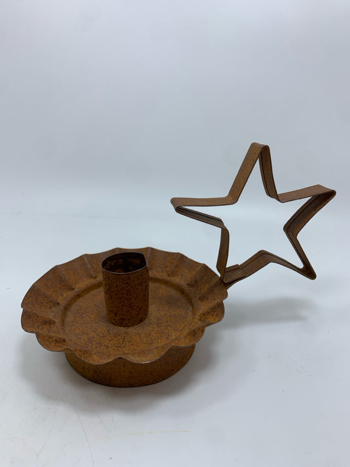 PRIMITIVE BROWN METAL STAR CANDLESTICK HOLDER.