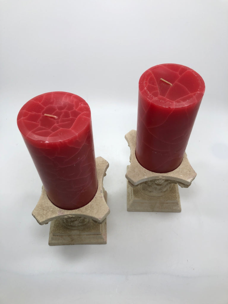 2 ROMAN COLUMN CERAMIC CANDLE HOLDERS W/RED CANDLES.