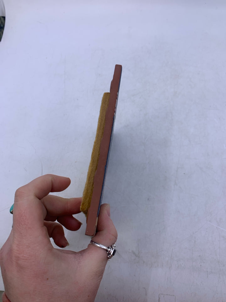 TERRA COTTA WOLF HOWLING AT THE MOON NEXT TO CACTUS.