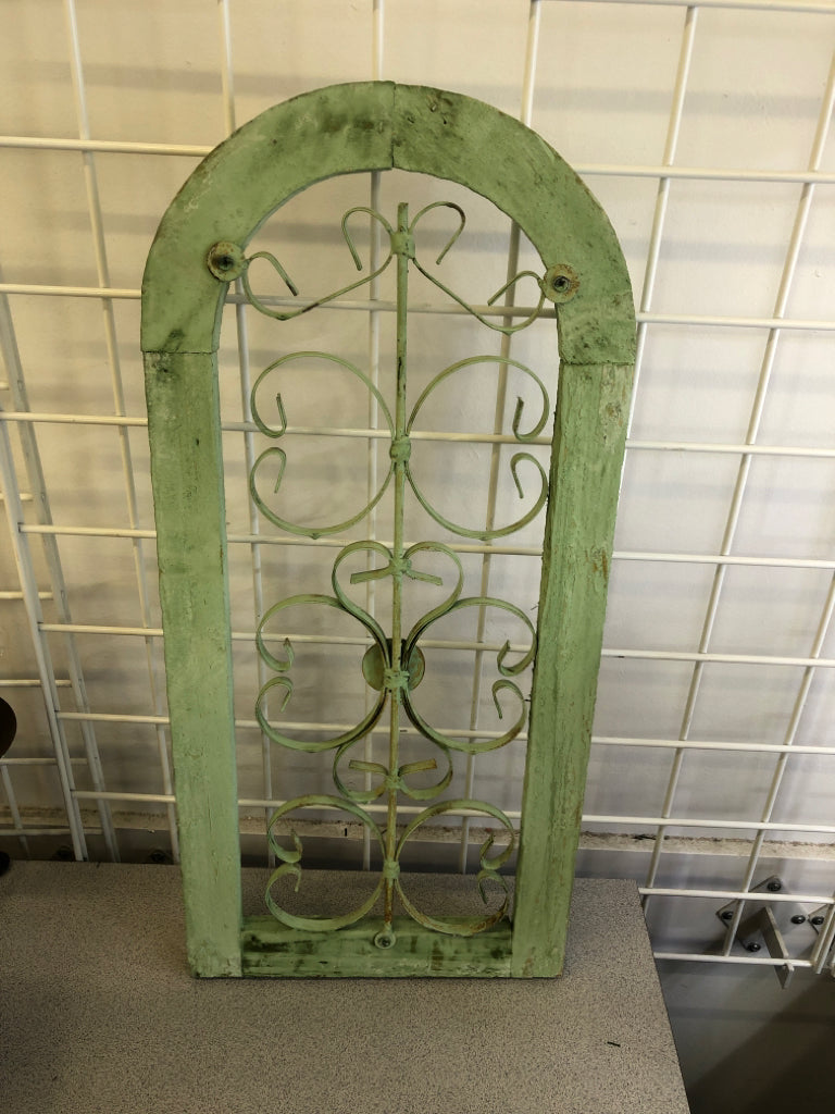 DISTRESSED GREEN PAINTED ARCH W/ METAL SCROLL WALL ART.