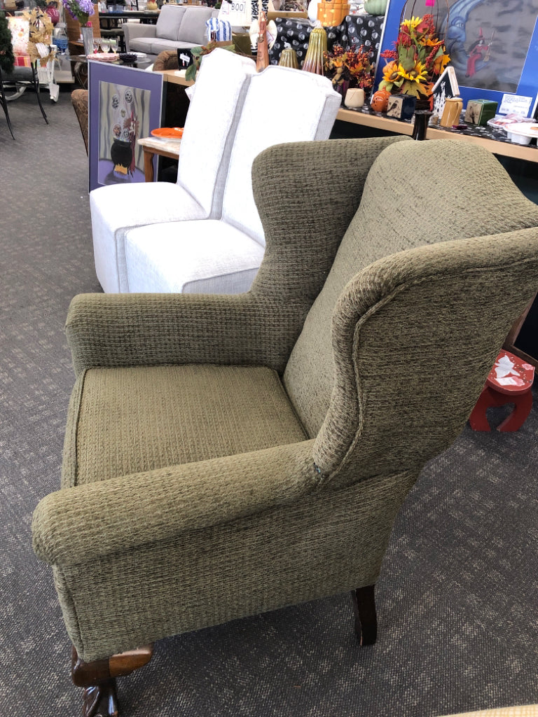 GREEN WING BACK CHAIR W DARK WOOD LEGS.