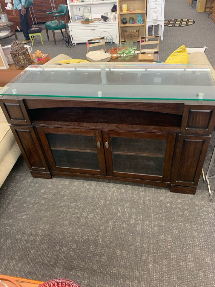 HEAVY DARK WOOD AND GLASS ENTERTAINMENT CENTER WITH SHELF AND CABINET STORAGE.