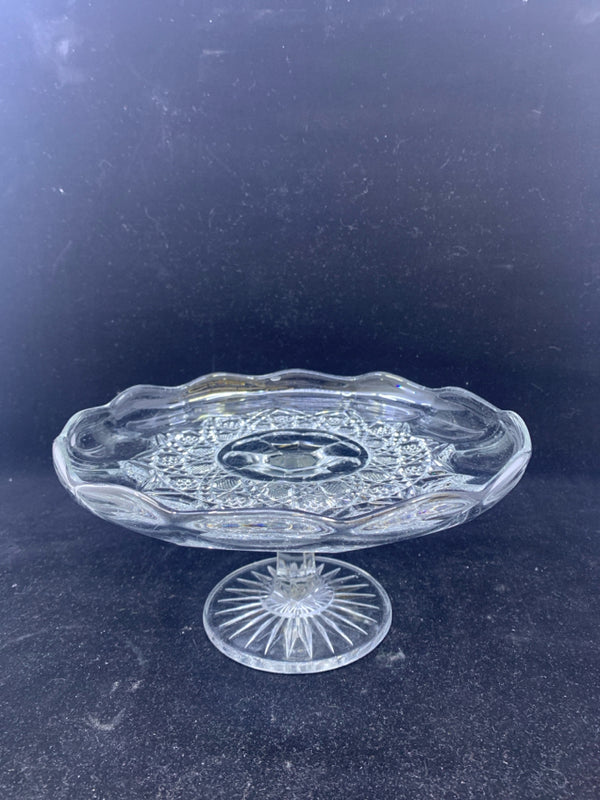 SMALL GLASS FOOTED PLATTER W/ STAR DESIGN IN MIDDLE W/ SCALLOP EDGE.