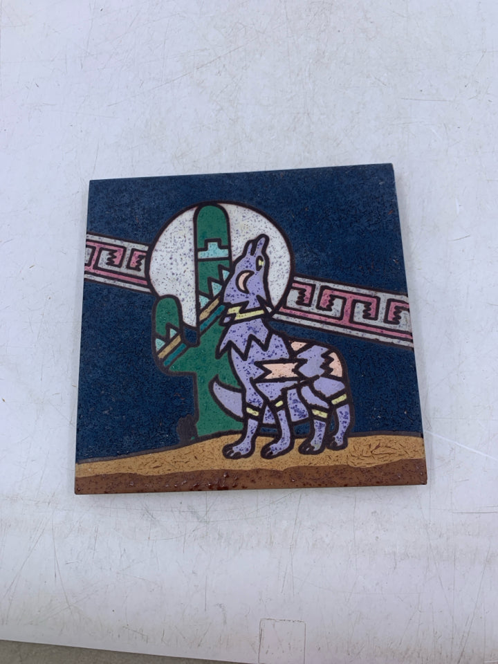 TERRA COTTA WOLF HOWLING AT THE MOON NEXT TO CACTUS.