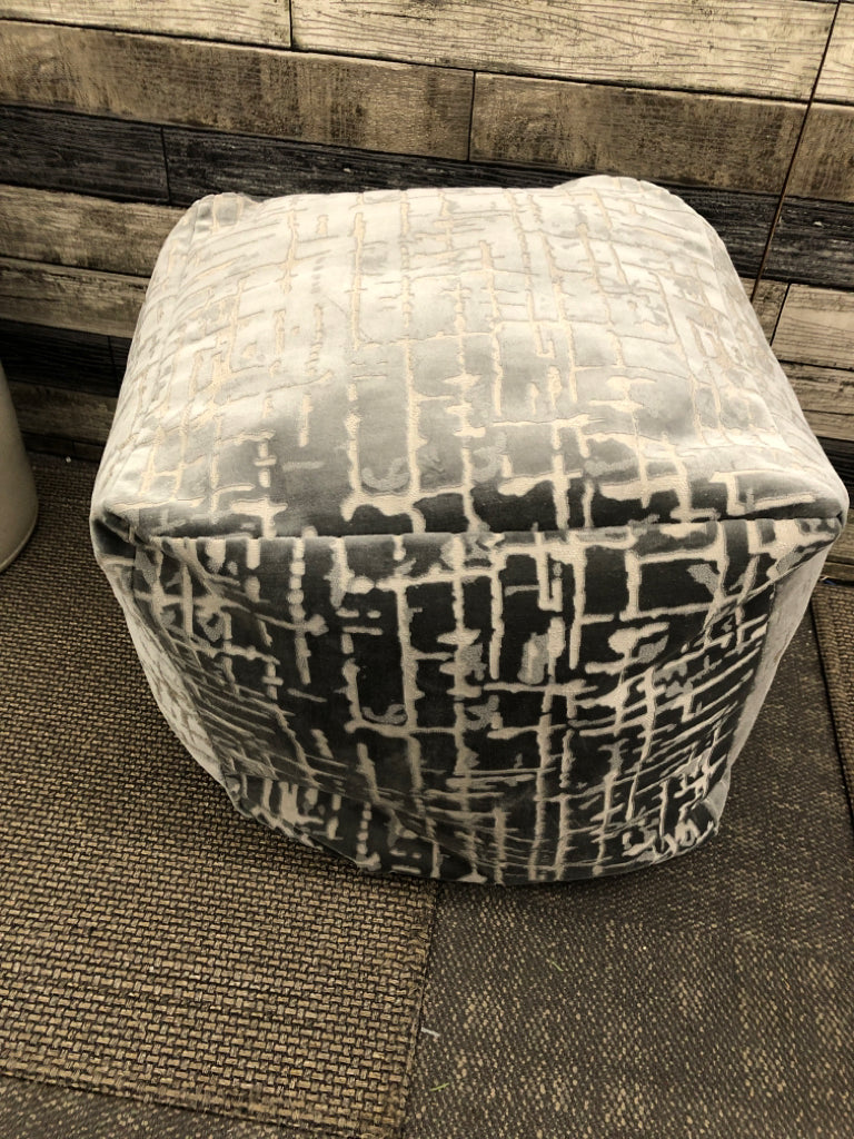 LARGE GREY OTTOMAN CUBE W/CUTOUT DETAILS.