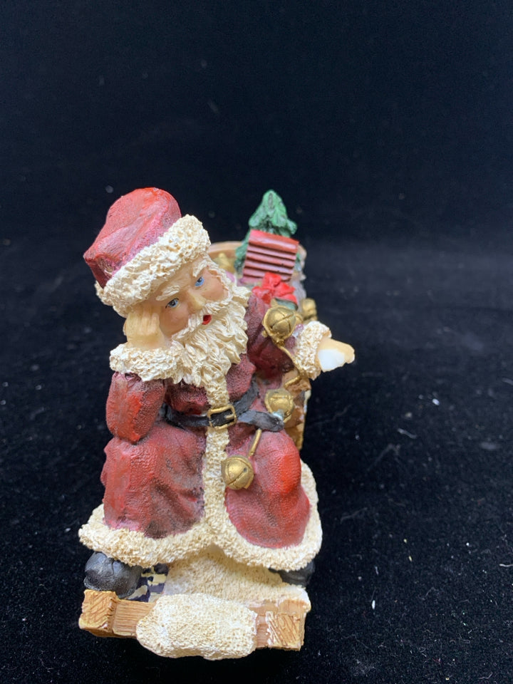 SANTA SITTING ON SLEIGH W TOYS.