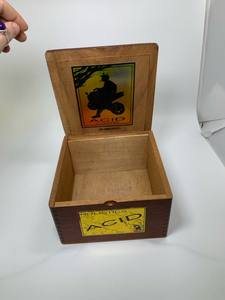 "ACID CIGARS" BOX MAN LEANING ON BIKE.