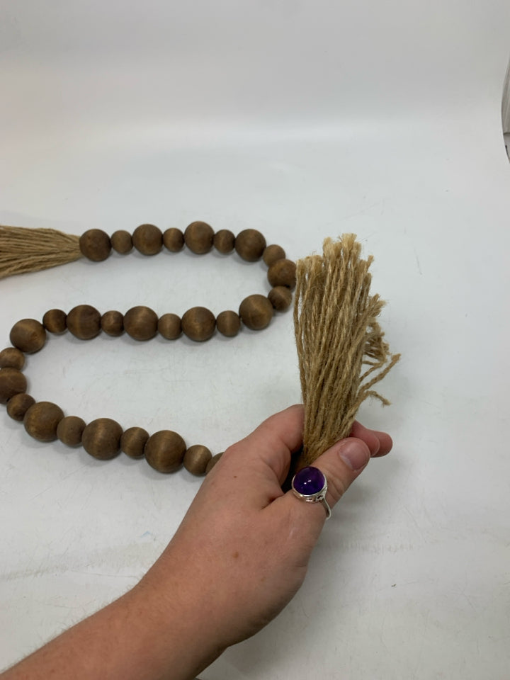 WOOD BEADED GARLAND W/ TWINE TASSELS.