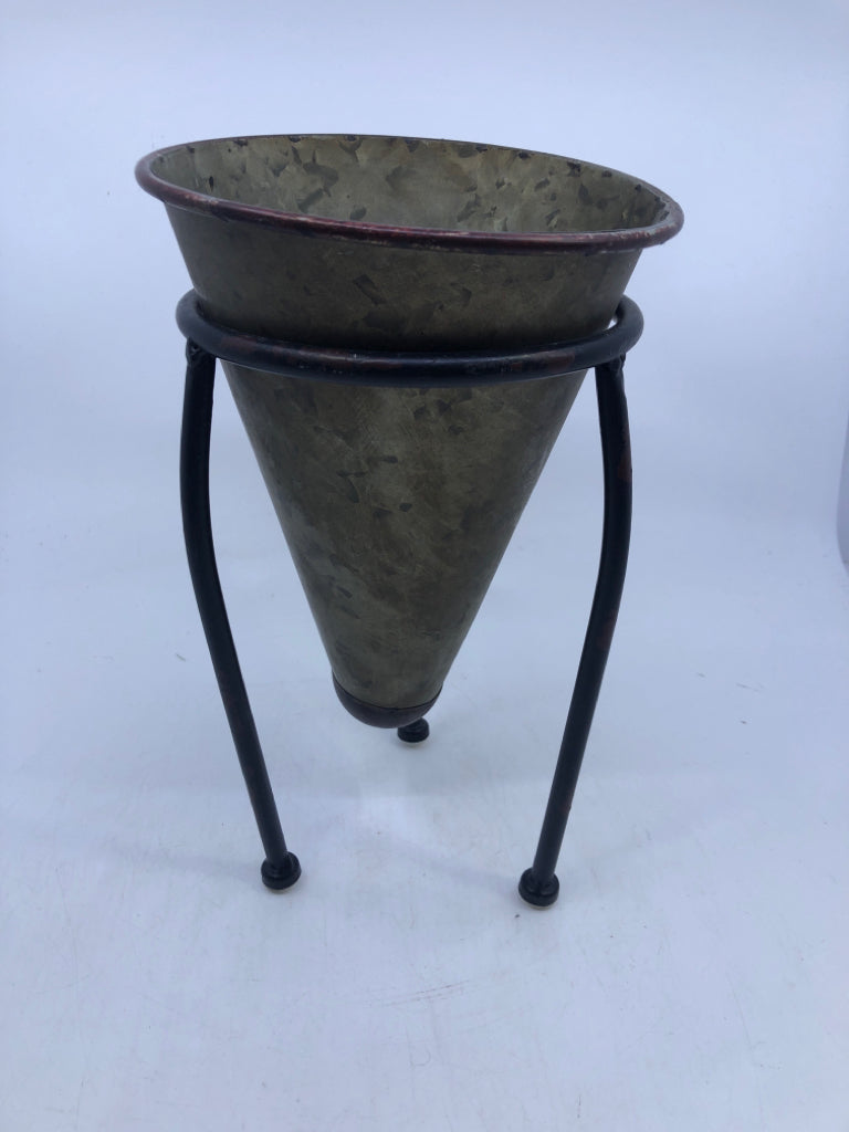 GALVANIZED CONE SHAPED PLANTER IN BLACK FOOTED STAND.