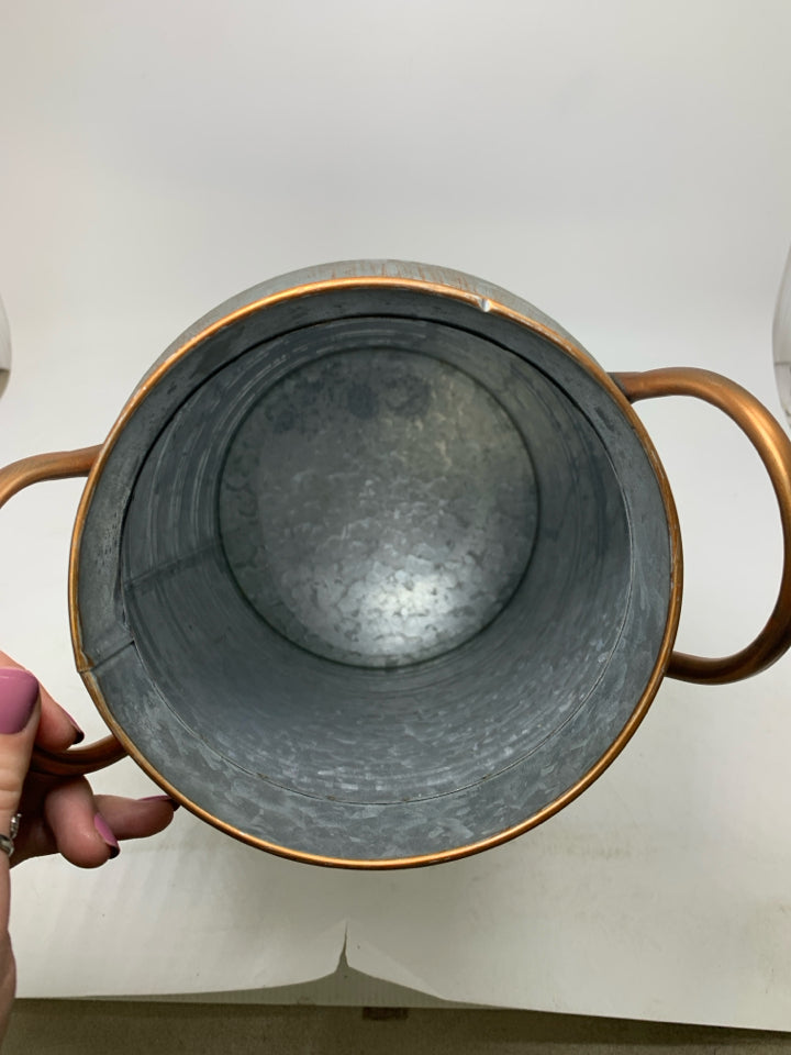 GALVANIZED BUCKET W/ COPPER COLORED DETAILS.