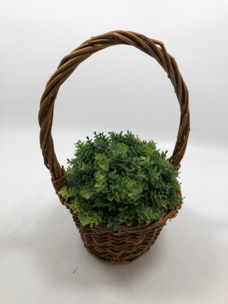 FAUX GREENERY IN HANGING WICKER BASKET.