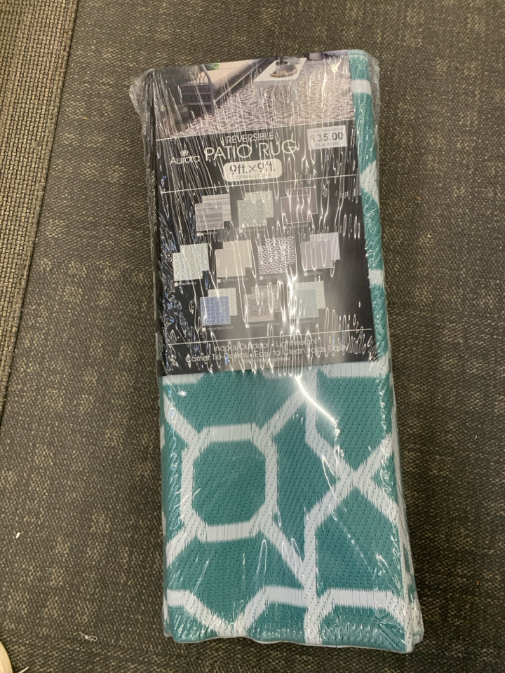 NIP REVERSIBLE PATIO RUG.