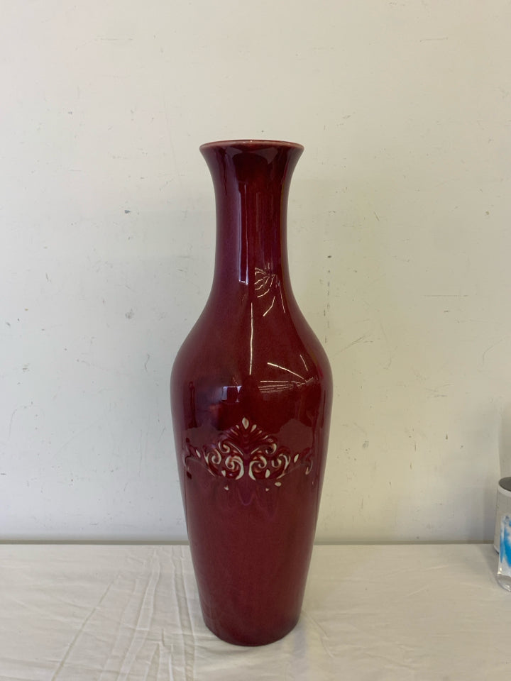 LARGE RED FLOOR VASE W EMBOSSED SCROLL DETAIL.