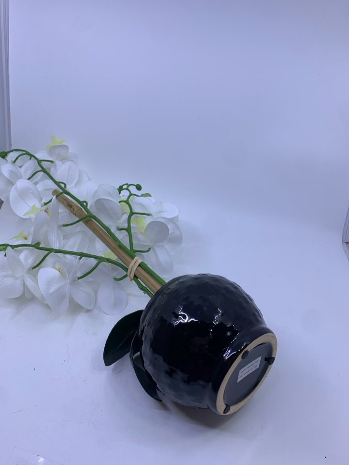 FAUX WHITE ORCHID FLORAL IN BLACK PLANTER.