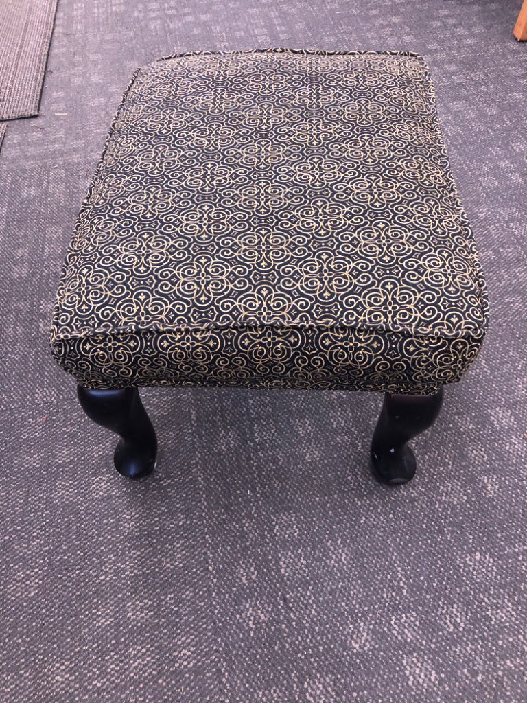 BLACK AND GOLD SCROLL PATTERN OTTOMAN.