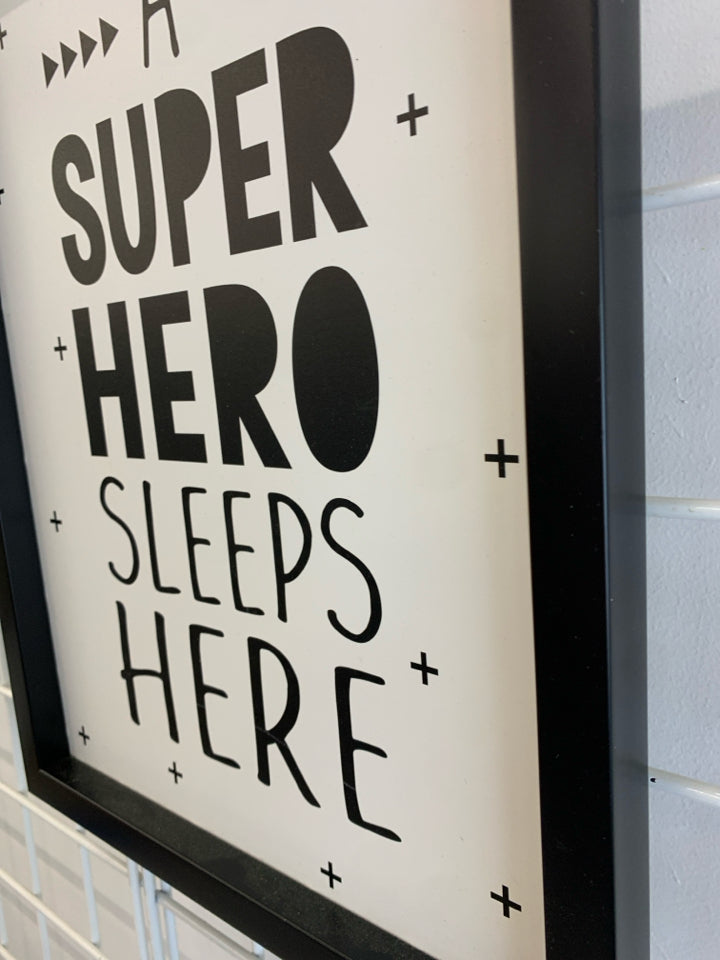 A SUPER HERO SLEEPS HERE WALL-HANGING.
