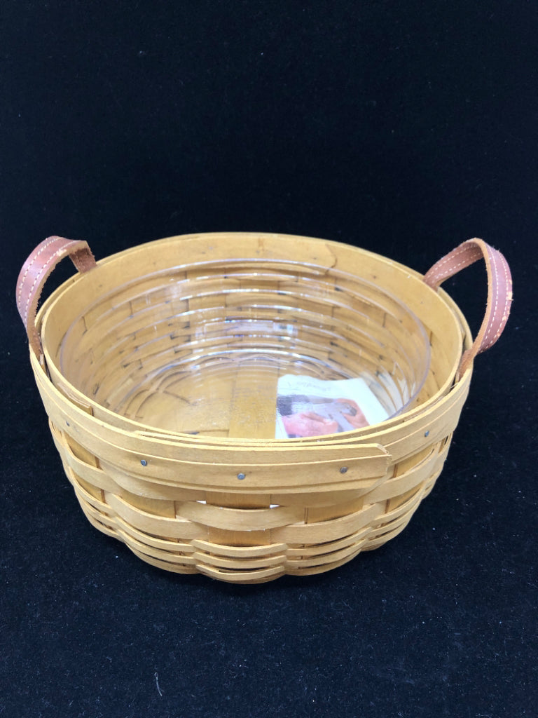 ROUND BASKET W PLASTIC LINER AND LEATHER HANDLES.