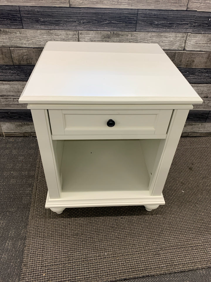 WHITE NIGHT STAND W/ DRAWER BLACK HARDWARE.