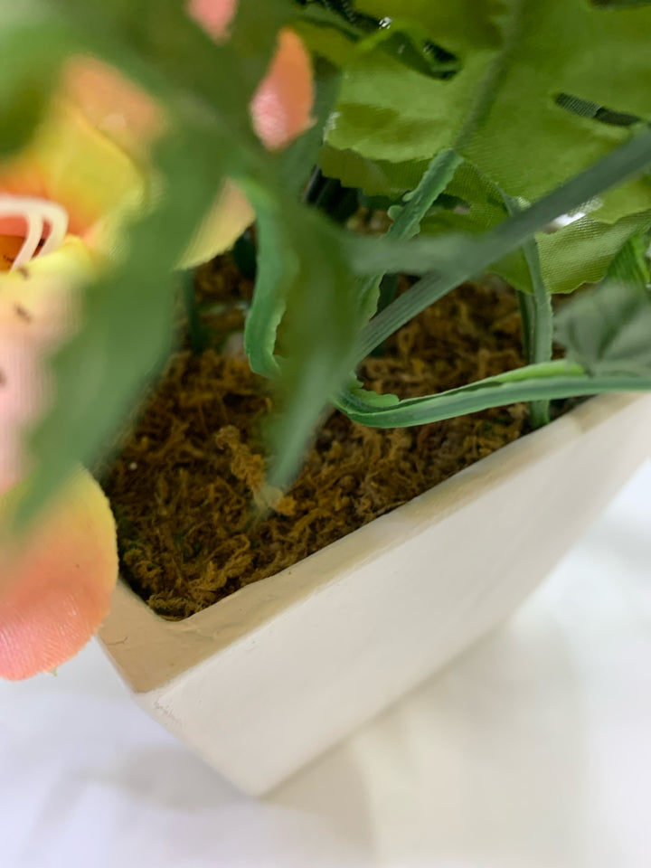 PINK & YELLOW FLORALS IN WHITE SQUARE POT.