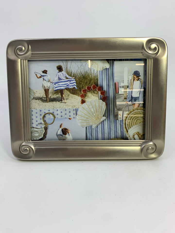 SILVER METAL PHOTO FRAME W/SWIRLED CORNERS.