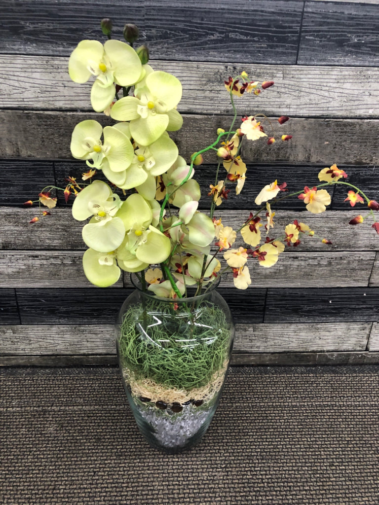 FAUX YELLOW ORCHIDS IN MARBLE FILLED VASE.