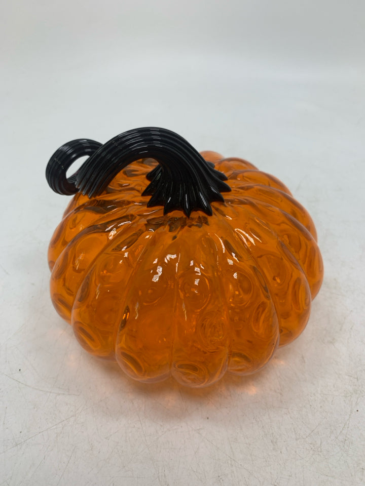 ORANGE GLASS PUMPKIN WITH BLACK STEM.