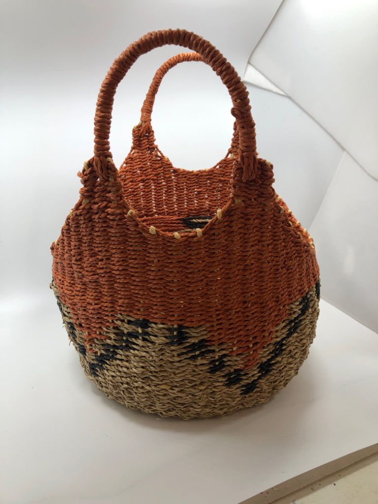 ORANGE AND TAN WICKER BASKET WITH BLUE ACCENTS.