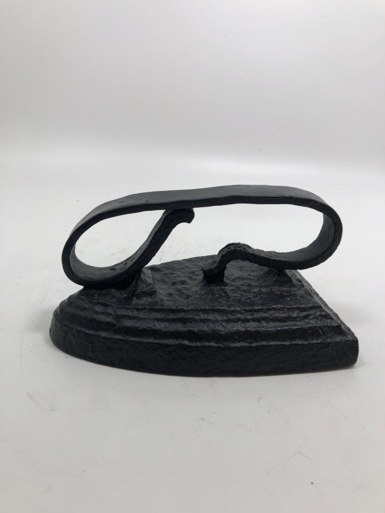 BLACK SAD IRON DOOR STOP.