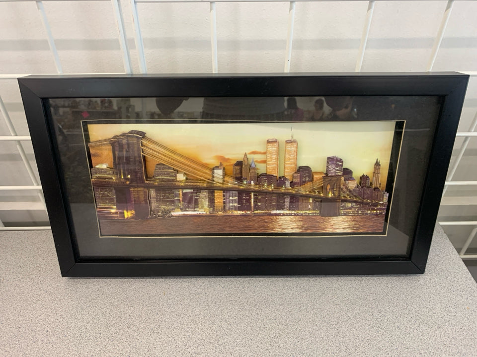 LAYERED CITY SKYLINE IN BLACK FRAME.