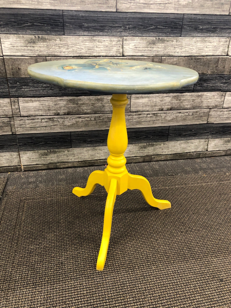 YELLOW/TEAL PAINTED PLANT STAND W/FLOWERS.